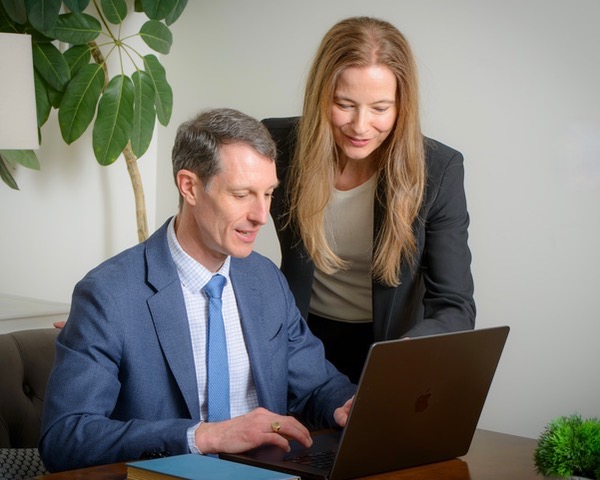 Cindy Brown conducting a case review with Colin Brown at the Vindex Law office